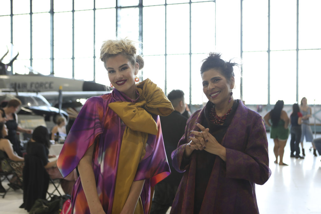 Oversized bows, purples and golds in the couture Golden Dreams collection by Brooks LTD, seen at Latin Fashion Week Colorado